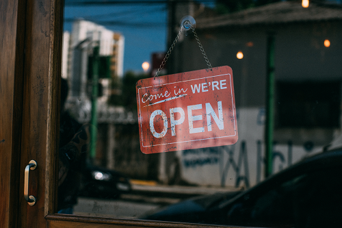 a close up of an open sign on a business window