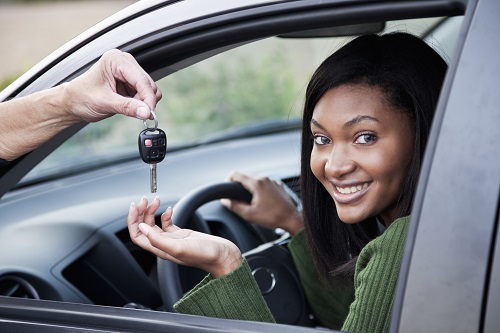 girl getting handed car keys 